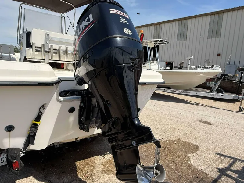 Slide: The Image of 1999 Hydra-Sports 22 Bay Sport boat with Suzuki outboard motor in a marina setting. - 11