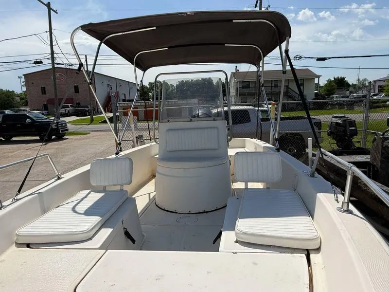 Slide: The Image of 1999 Hydra-Sports 22 Bay Sport boat with seating and canopy in a parking area. - 5