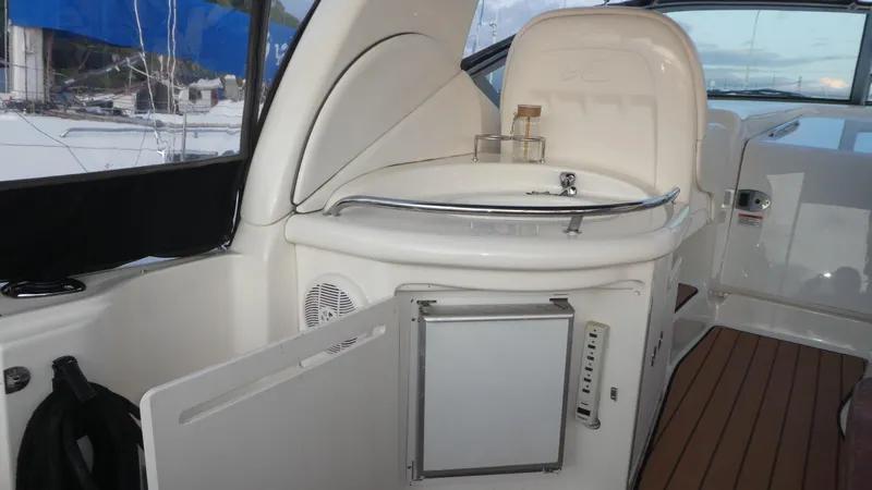 Slide: The Image of 2007 Sea Ray 340 Sundancer interior with open mini fridge and sleek design. - 11
