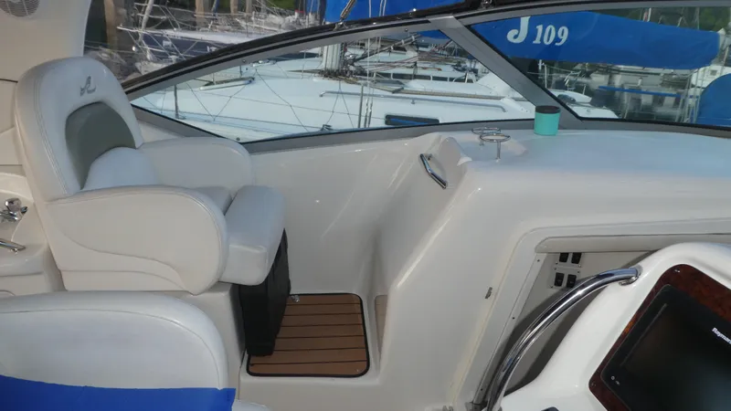 Slide: The Image of 2007 Sea Ray 340 Sundancer cockpit with white seating and wooden flooring. - 12