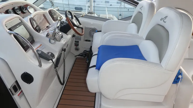 Slide: The Image of 2007 Sea Ray 340 Sundancer helm with white seats and wooden flooring. - 13