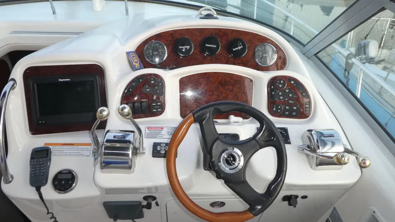 Slide: The Image of 2007 Sea Ray 340 Sundancer helm with wood accents and modern controls. - 14