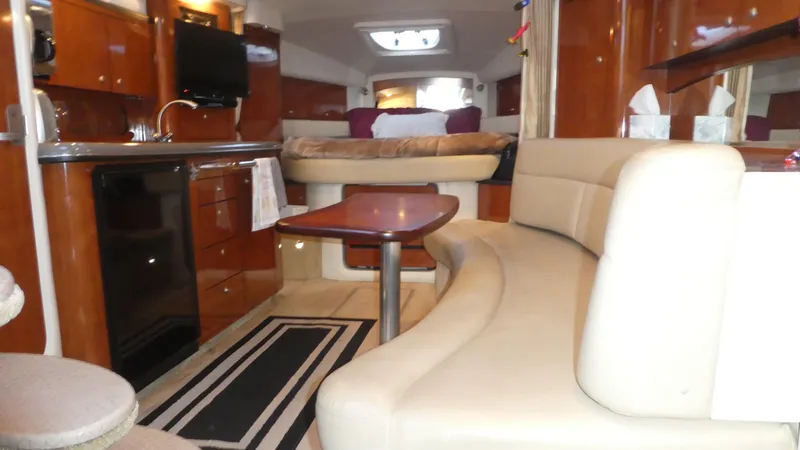 Slide: The Image of Interior of 2007 Sea Ray 340 Sundancer yacht with modern kitchen and seating area. - 17