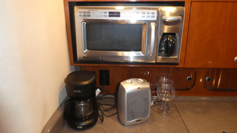 Slide: The Image of 2007 Sea Ray 340 Sundancer galley with microwave, coffee maker, and heater. - 21