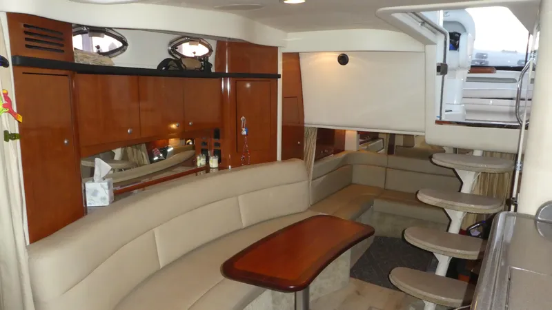 Slide: The Image of Luxurious interior of 2007 Sea Ray 340 Sundancer yacht with elegant seating and wooden cabinetry. - 23