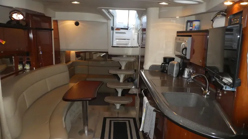 Slide: The Image of Interior of 2007 Sea Ray 340 Sundancer yacht with kitchen and seating area. - 25