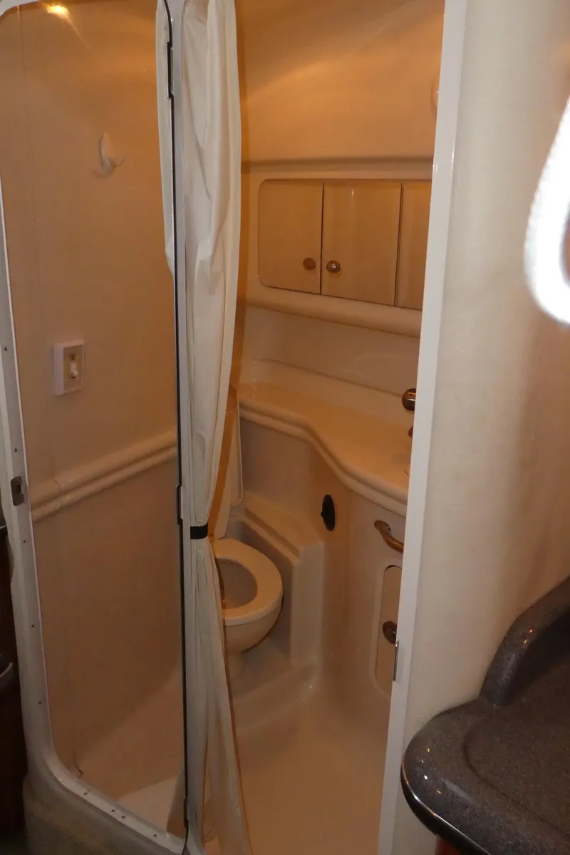 Slide: The Image of 2007 Sea Ray 340 Sundancer bathroom with shower, compact design, white interior. - 27