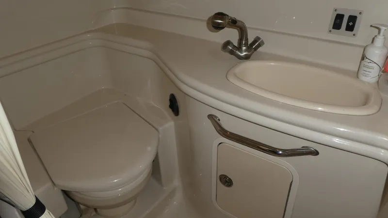 Slide: The Image of 2007 Sea Ray 340 Sundancer bathroom with sink, toilet, and storage cabinet. - 28
