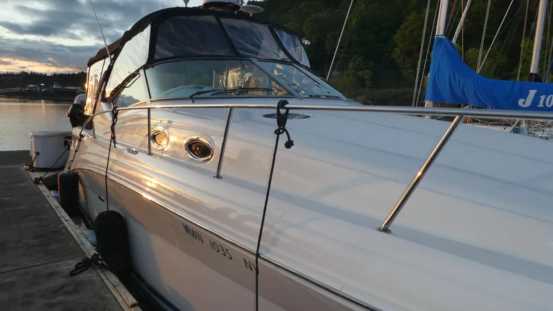 Slide: The Image of 2007 Sea Ray 340 Sundancer docked at sunset, reflecting golden light on water. - 3