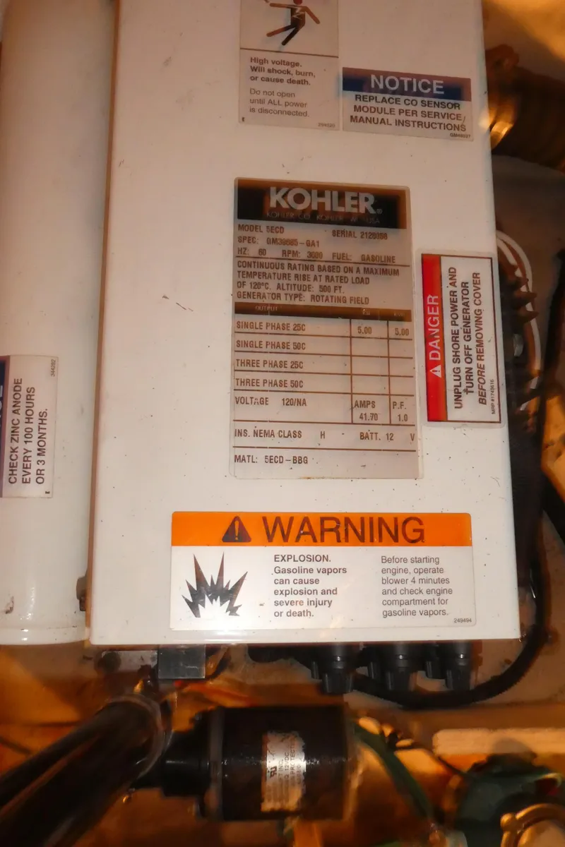 Slide: The Image of Kohler generator panel with warning labels on a 2007 Sea Ray 340 Sundancer. - 36