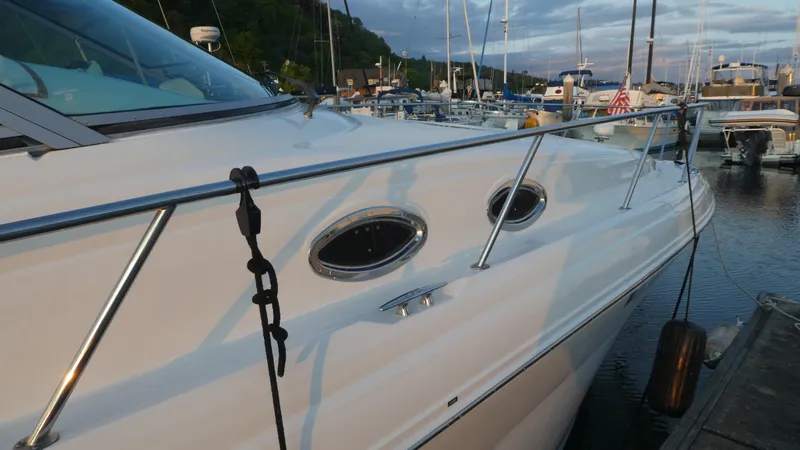 Slide: The Image of 2007 Sea Ray 340 Sundancer docked at marina, side view with portholes. - 4