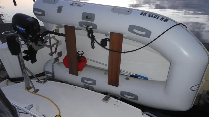 Slide: The Image of Inflatable dinghy mounted on 2007 Sea Ray 340 Sundancer boat with outboard motor. - 41