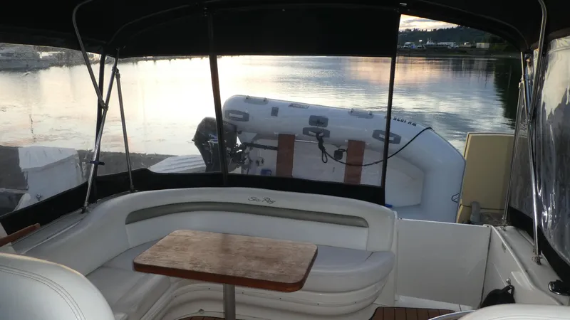 Slide: The Image of 2007 Sea Ray 340 Sundancer interior with seating and table, overlooking calm waters. - 8