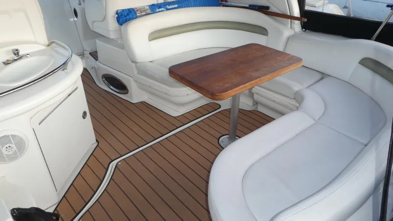 Slide: The Image of 2007 Sea Ray 340 Sundancer interior with white seating, wooden table, and sleek design. - 9