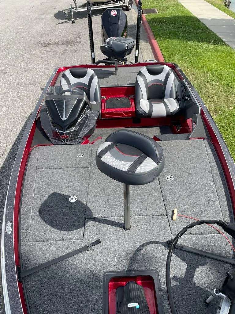 Slide: The Image of 2019 Ranger Z518L fishing boat with seating and storage, parked on pavement. - 3