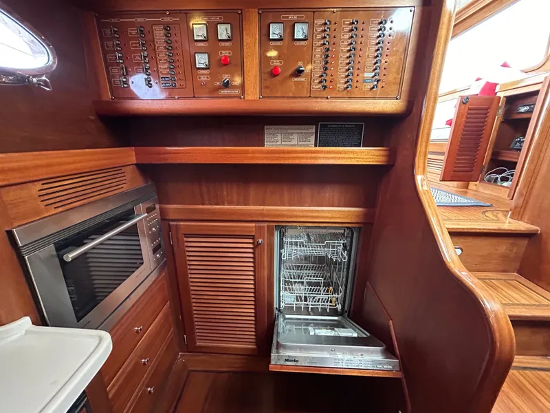 Slide: The Image of Luxurious 2003 Vicem 51 Classic yacht interior with wood paneling, control panels, and modern appliances. - 10