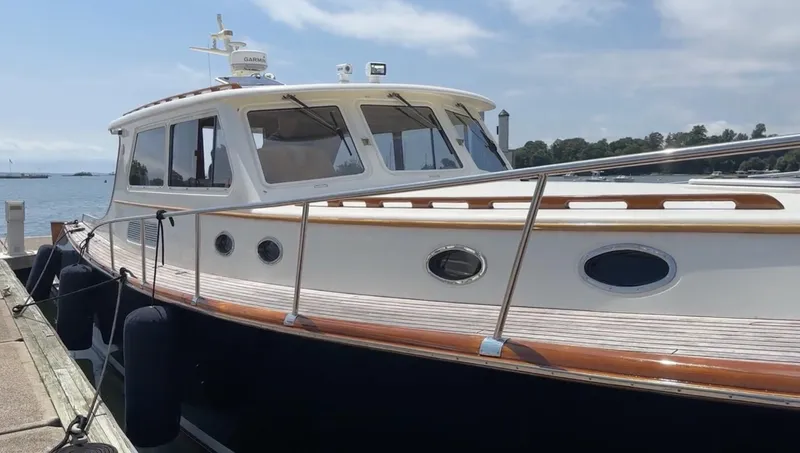 Slide: The Image of 2003 Vicem 51 Classic yacht docked by the water on a sunny day. - 2