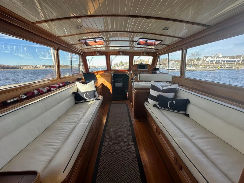 Slide: The Image of 2003 Vicem 51 Classic yacht interior with elegant wood finish and white seating. - 7