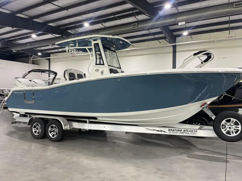 Slide: The Image of 2025 Tidewater 272 boat on trailer in indoor showroom. - 0