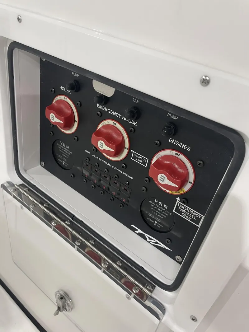 Slide: The Image of Control panel of 2025 Tidewater 272 boat with red switches and labeled functions. - 3