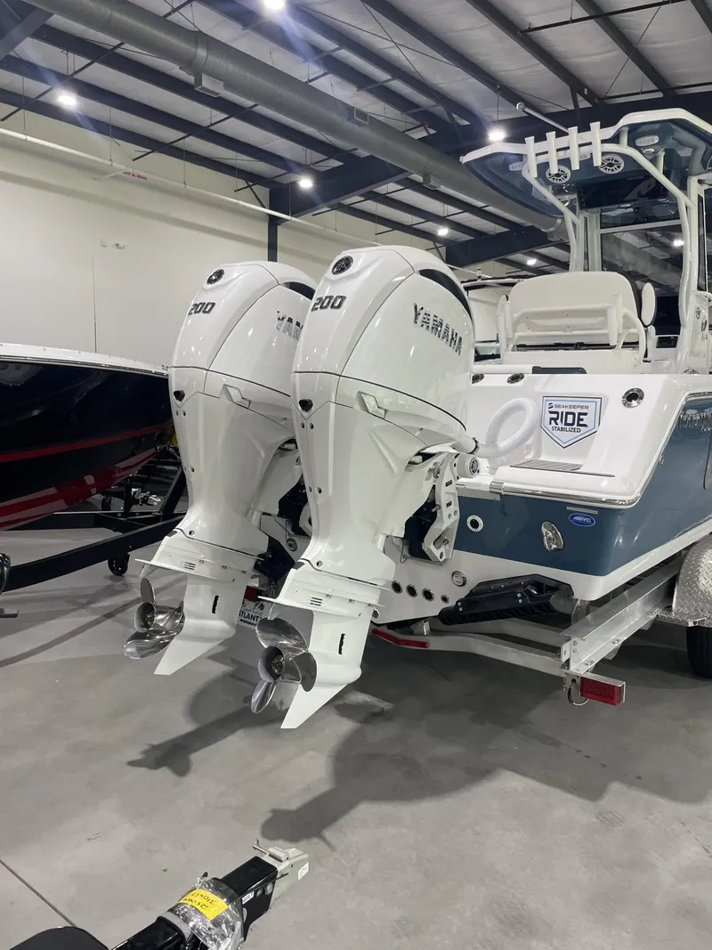Slide: The Image of 2025 Tidewater 272 boat with dual Yamaha outboard engines in a showroom. - 7
