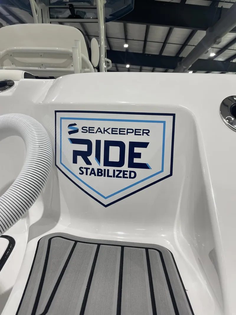 Slide: The Image of 2025 Tidewater 272 boat featuring Seakeeper Ride stabilization technology in a showroom setting. - 8