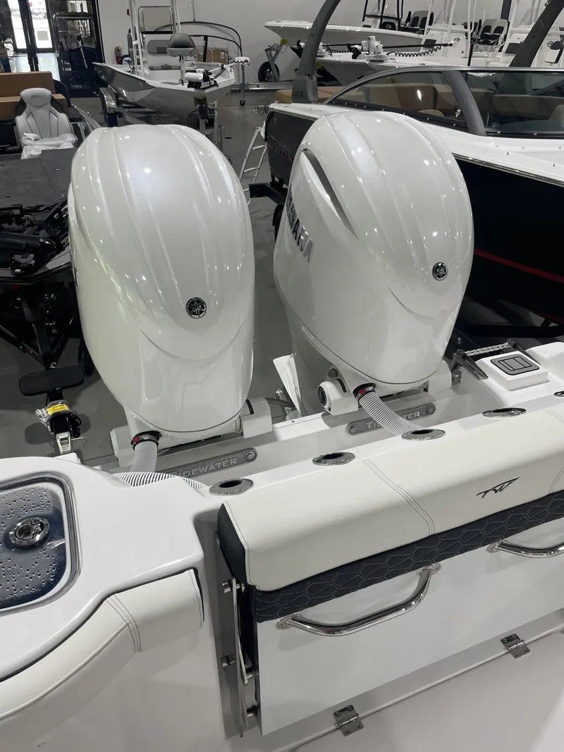 Slide: The Image of 2025 Tidewater 272 boat with dual outboard engines in showroom. - 9