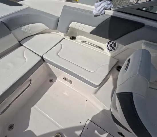 Slide: The Image of 2022 Chaparral 23 SSi OB boat interior, featuring sleek white seating and modern design. - 15