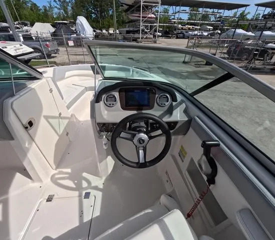 Slide: The Image of 2022 Chaparral 23 SSi OB boat interior, featuring steering wheel and dashboard controls. - 17