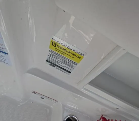 Slide: The Image of 2022 Chaparral 23 SSi OB boat capacity label, maximum 13 persons or 1,785 lbs. - 19