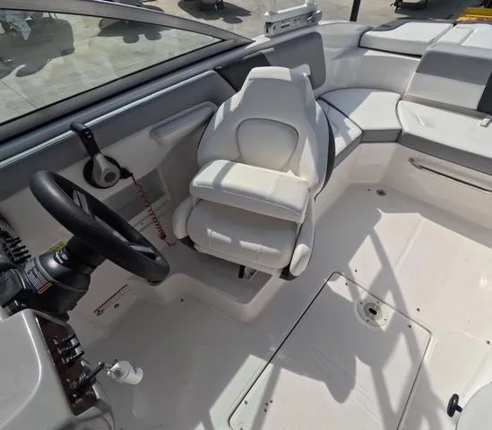 Slide: The Image of 2022 Chaparral 23 SSi OB boat interior, featuring a sleek white captain's seat. - 23