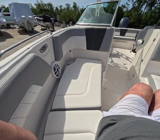 Slide: The Image of 2022 Chaparral 23 SSi OB boat interior, white seating, excellent condition, outdoor setting. - 27