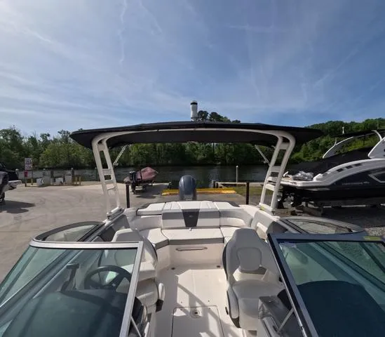 Slide: The Image of 2022 Chaparral 23 SSi OB boat in great condition, docked near a scenic waterfront. - 31