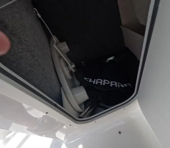 Slide: The Image of Storage compartment of 2022 Chaparral 23 SSi OB boat, featuring equipment and branded bag. - 35