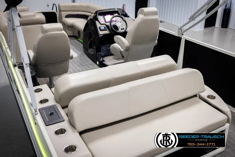 Slide: The Image of 2022 Premier 230 Solaris RL boat interior with beige seating and modern dashboard. - 11