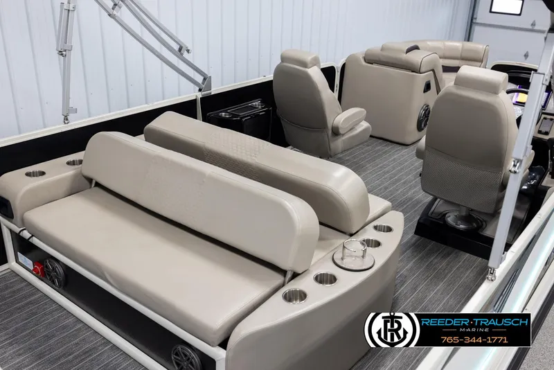 Slide: The Image of 2022 Premier 230 Solaris RL boat interior with beige seating and cup holders. - 12
