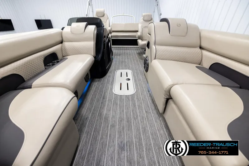 Slide: The Image of 2022 Premier 230 Solaris RL pontoon boat interior with beige seating and gray flooring. - 13