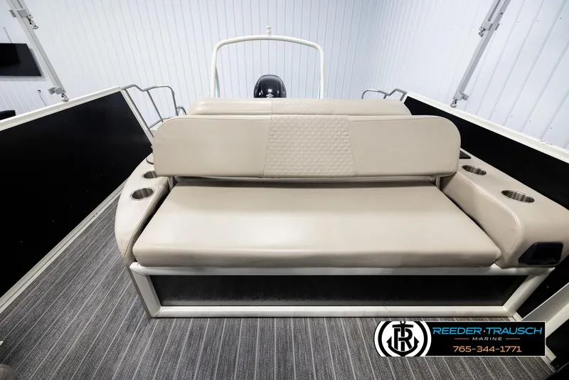 Slide: The Image of 2022 Premier 230 Solaris RL boat interior with beige seating and cup holders. - 15
