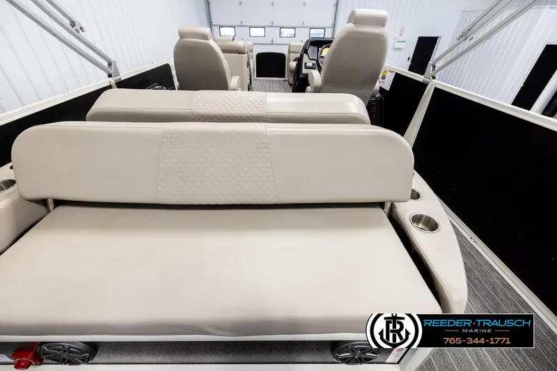 Slide: The Image of 2022 Premier 230 Solaris RL boat interior with beige seating and cup holders. - 16