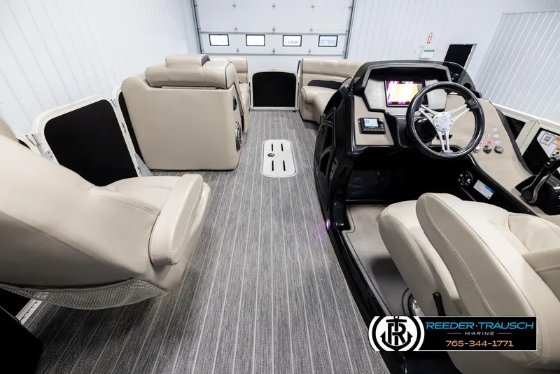 Slide: The Image of 2022 Premier 230 Solaris RL boat interior with luxurious seating and modern dashboard. - 17
