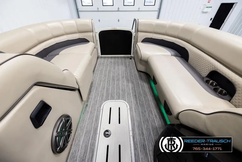 Slide: The Image of 2022 Premier 230 Solaris RL boat interior with beige seating and gray flooring. - 18