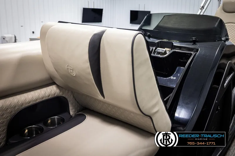 Slide: The Image of 2022 Premier 230 Solaris RL boat interior with beige seating and cup holders. - 20