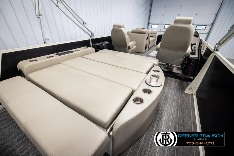 Slide: The Image of 2022 Premier 230 Solaris RL boat interior with beige seating and cup holders. - 23