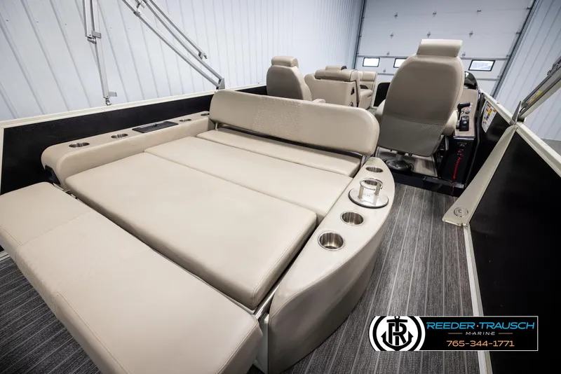 Slide: The Image of 2022 Premier 230 Solaris RL boat interior with beige seating and cup holders. - 24