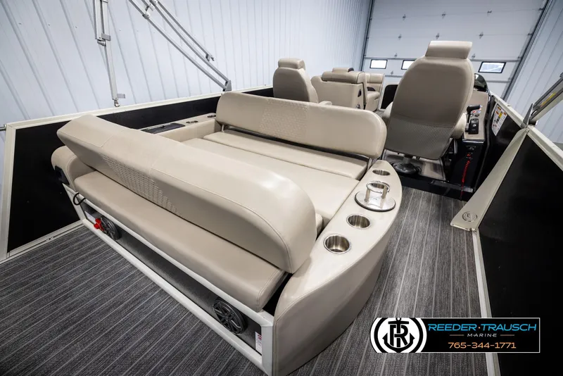 Slide: The Image of 2022 Premier 230 Solaris RL boat interior with beige seating and cup holders. - 25