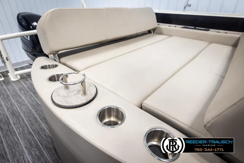 Slide: The Image of 2022 Premier 230 Solaris RL boat interior with beige seating and cup holders. - 27