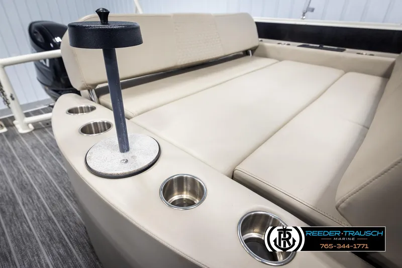 Slide: The Image of 2022 Premier 230 Solaris RL boat interior with beige seating and multiple cup holders. - 28