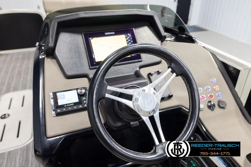 Slide: The Image of Steering console of 2022 Premier 230 Solaris RL boat with navigation display and controls. - 32