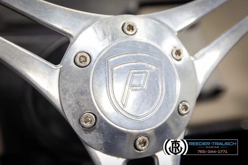 Slide: The Image of Steering wheel of 2022 Premier 230 Solaris RL boat, featuring a metallic design. - 33