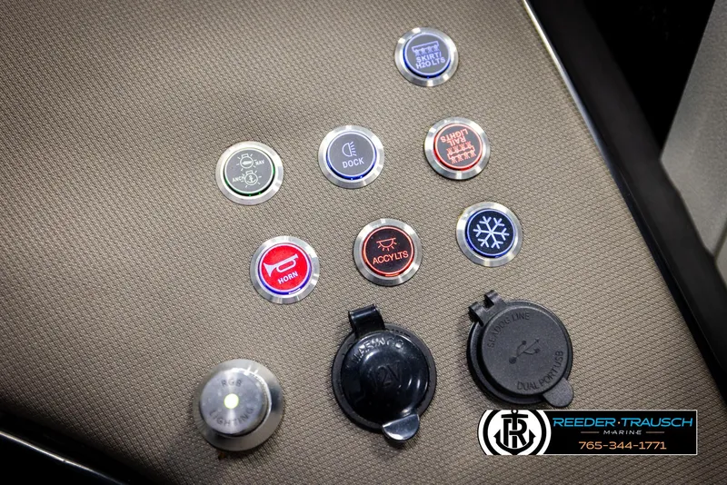 Slide: The Image of Buttons and controls on a 2022 Premier 230 Solaris RL boat dashboard. - 37